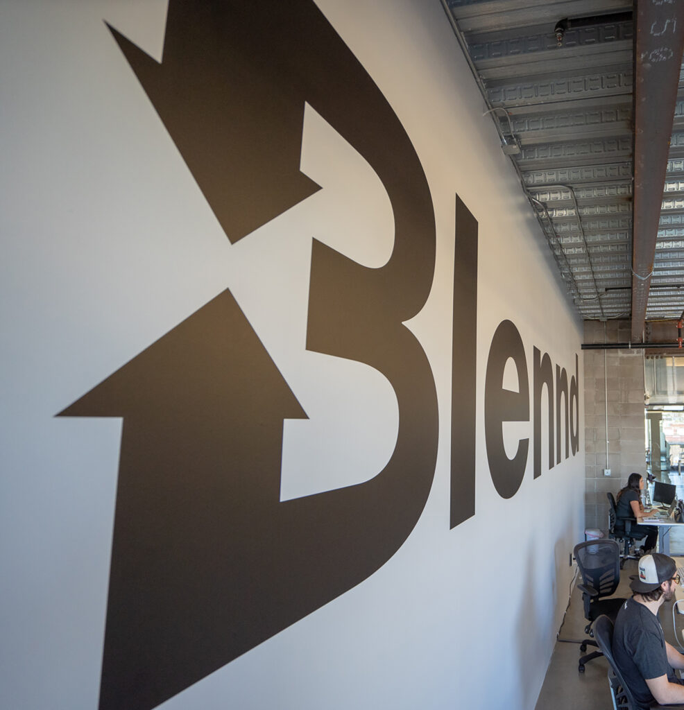 Blennd office wall with branded arrow graphic