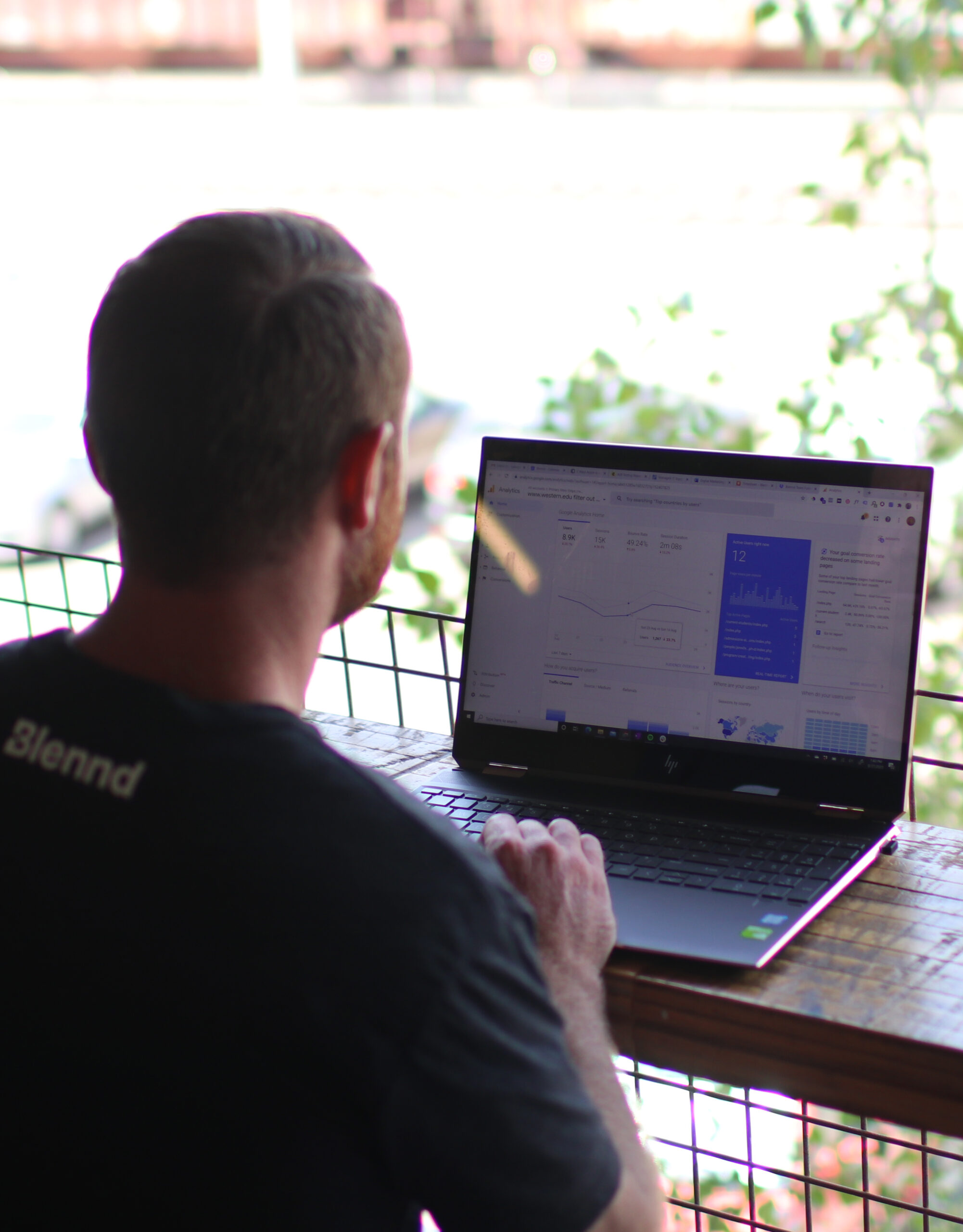 Developer working on laptop with website interface