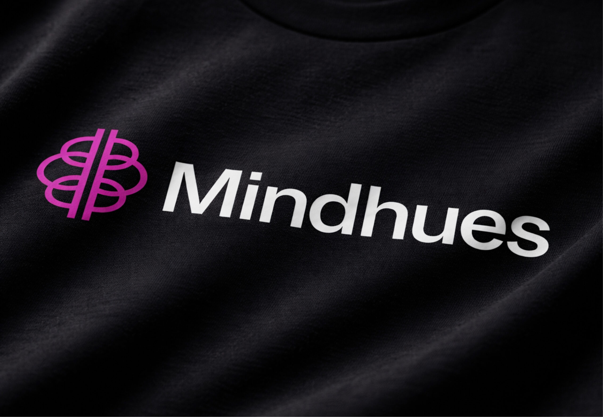 Mindhues brand logo on dark background