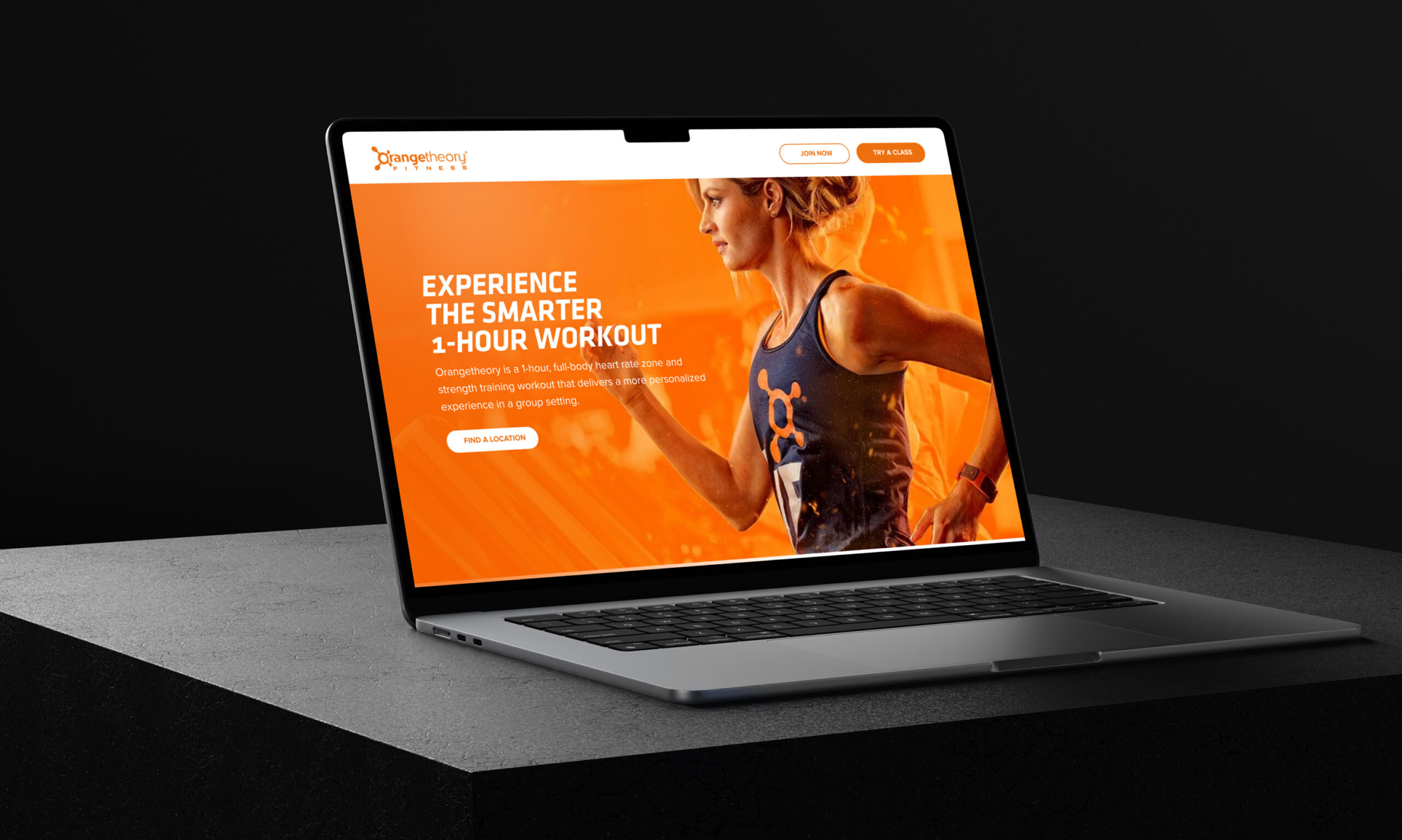 Laptop displaying website with orange branding