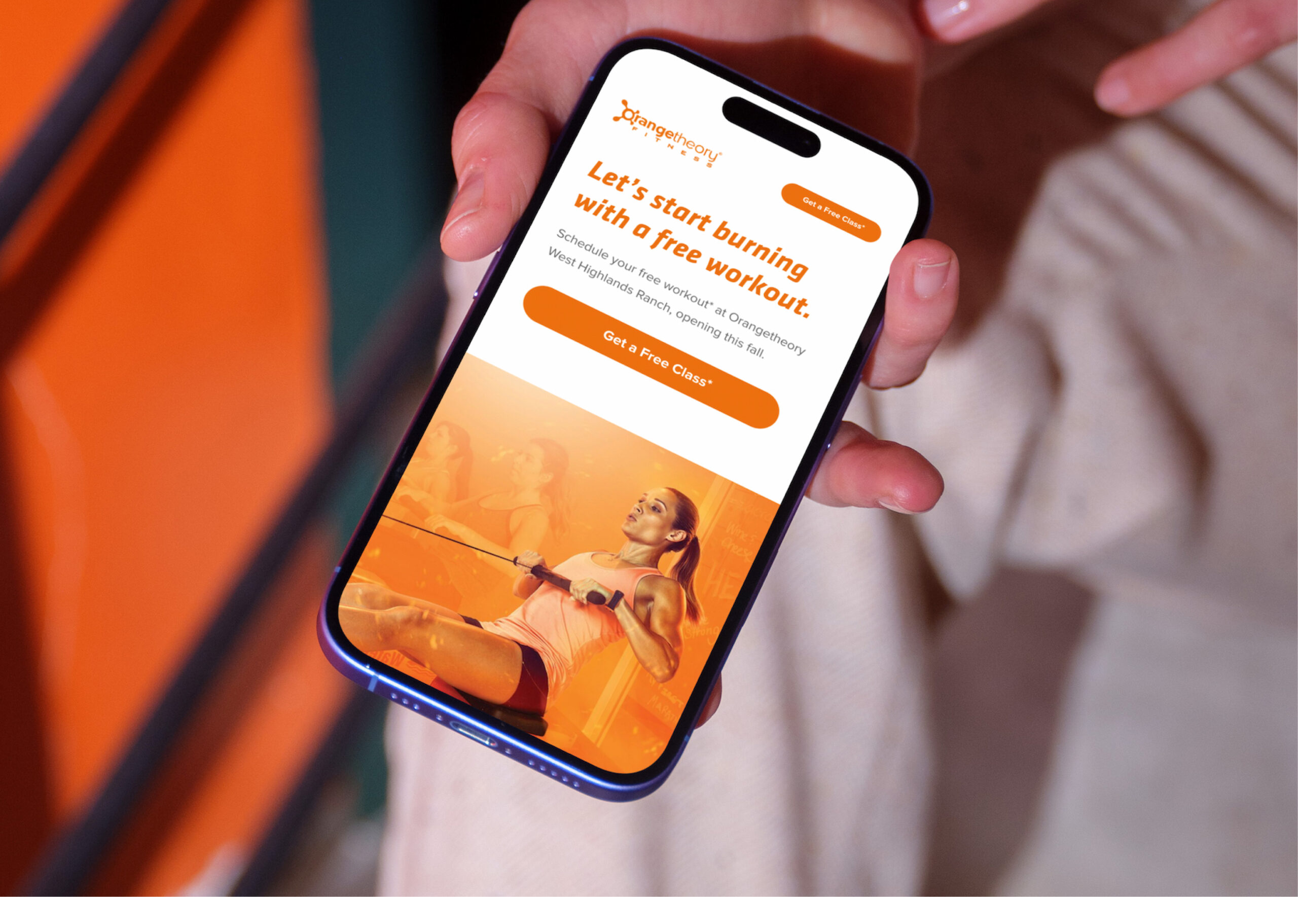 Smartphone displaying fitness app interface in hand