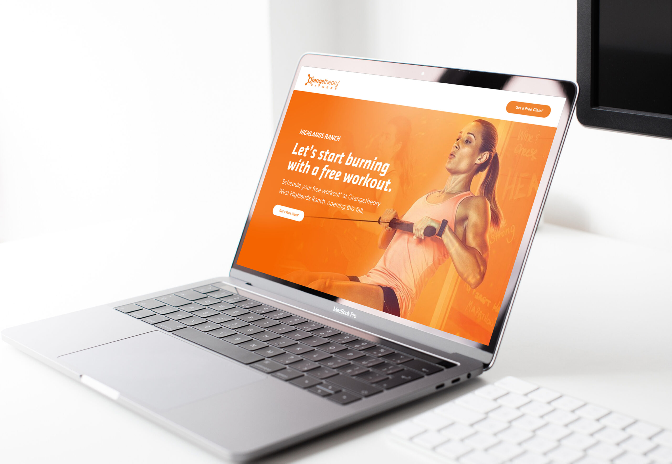 Laptop displaying fitness website homepage