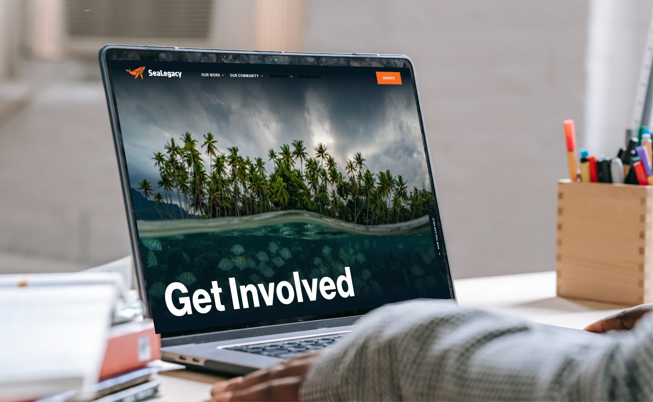 Laptop displaying website homepage on desk