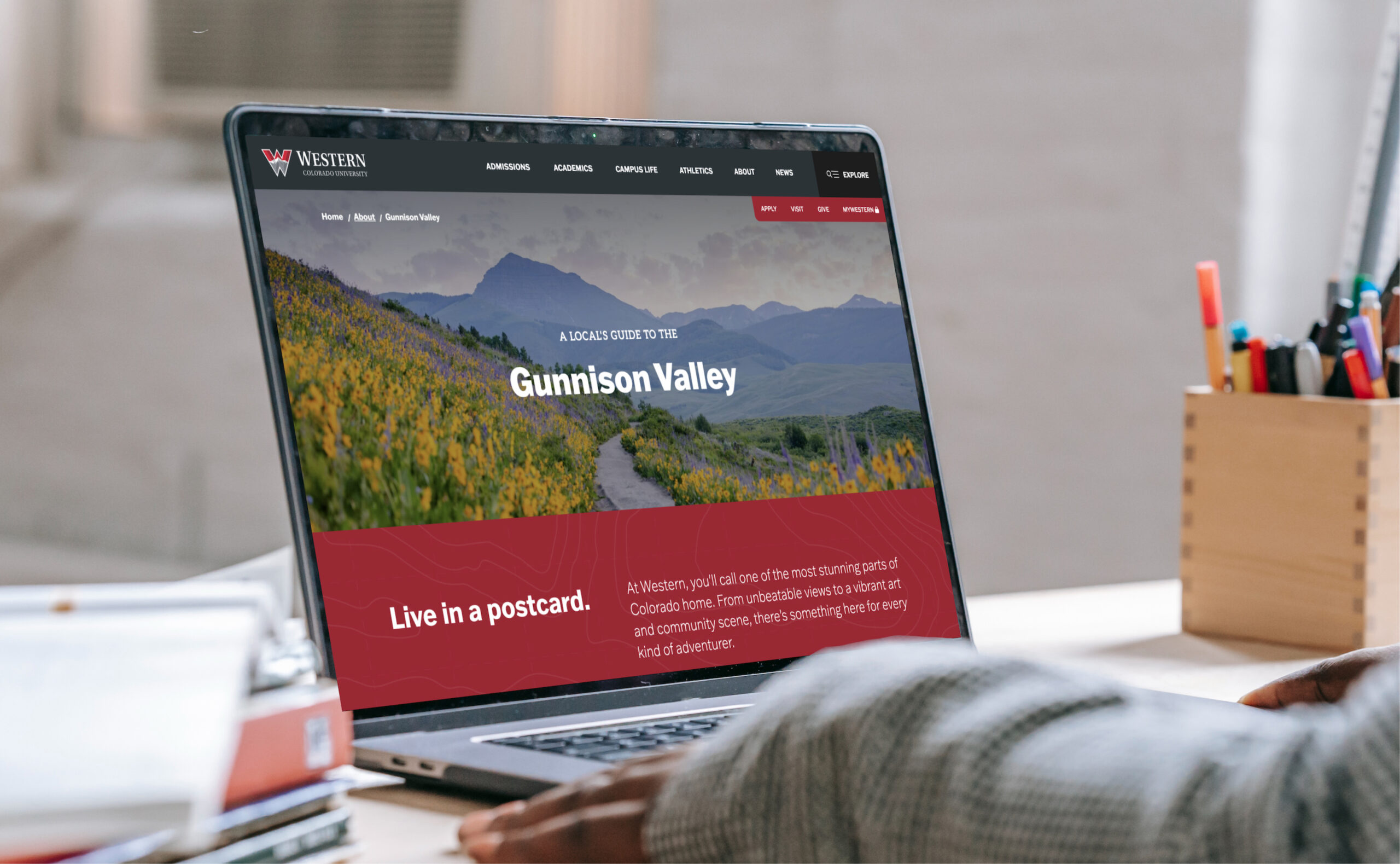 Laptop displaying website homepage on desk