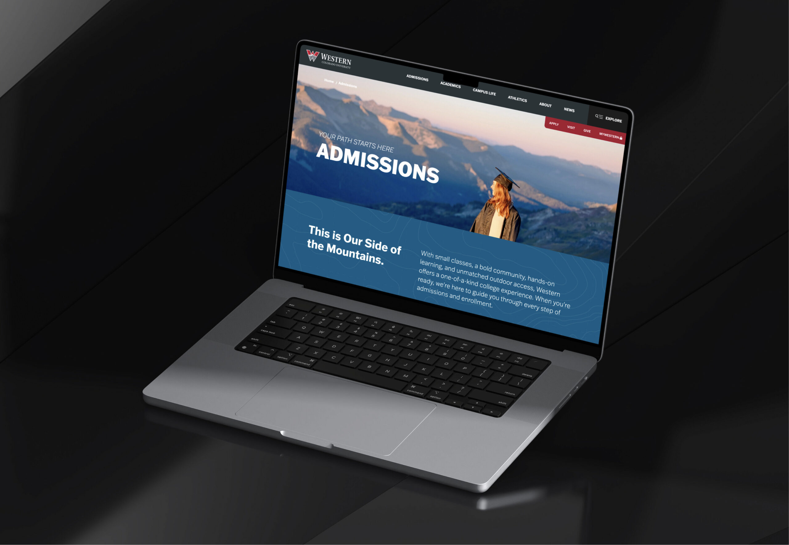 Laptop displaying website homepage on dark background