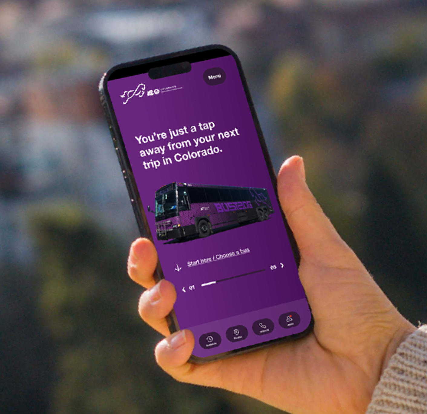 Smartphone displaying purple app interface in hand