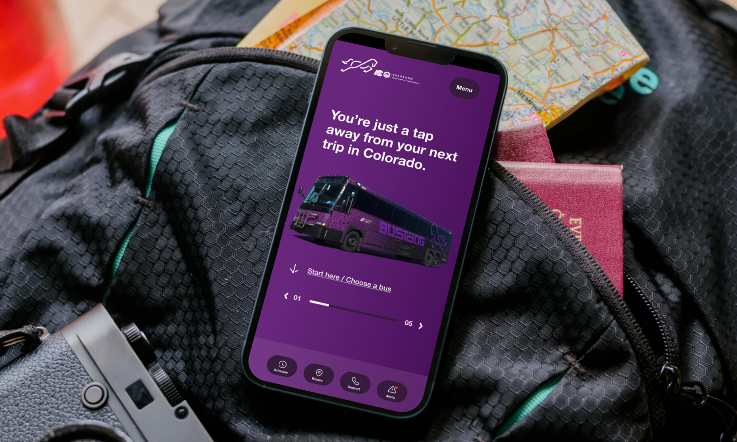 Mobile phone displaying purple app interface in bag
