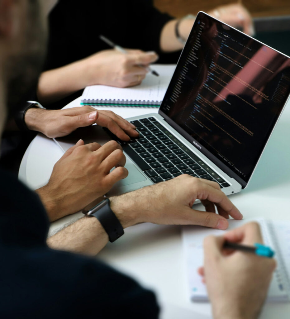 Team collaborating on laptop in office