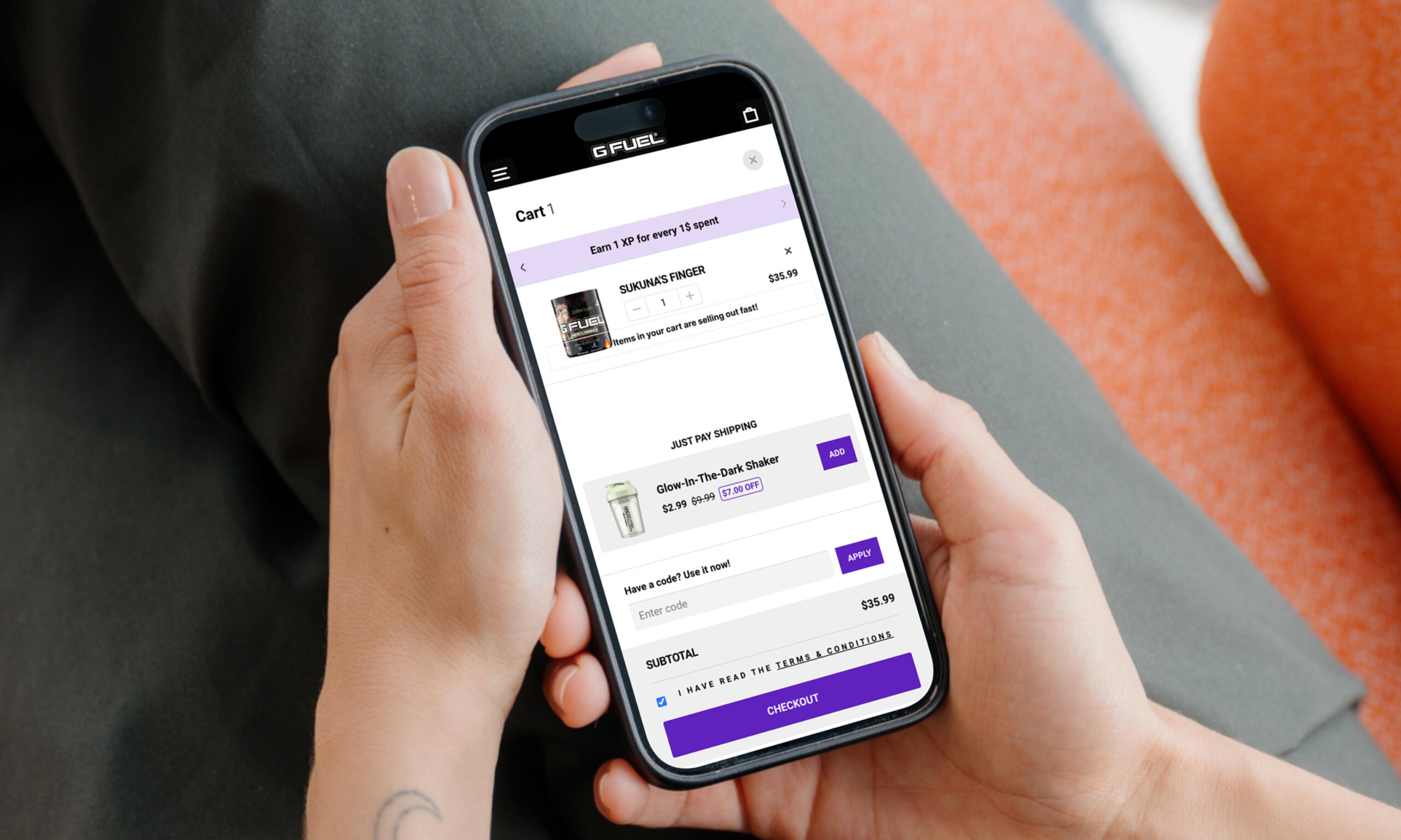 Mobile phone displaying app interface in hand