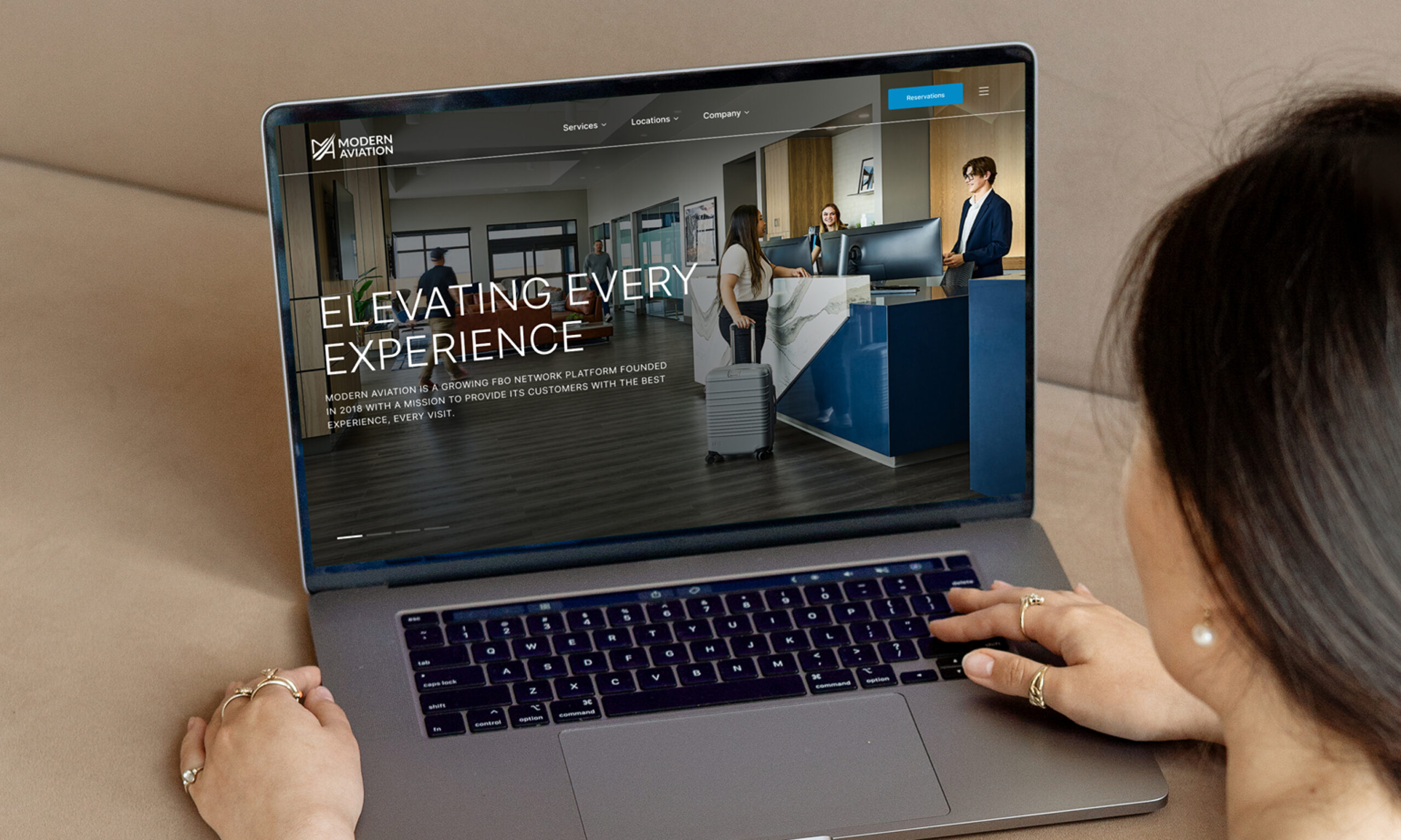 Laptop displaying website homepage in office setting