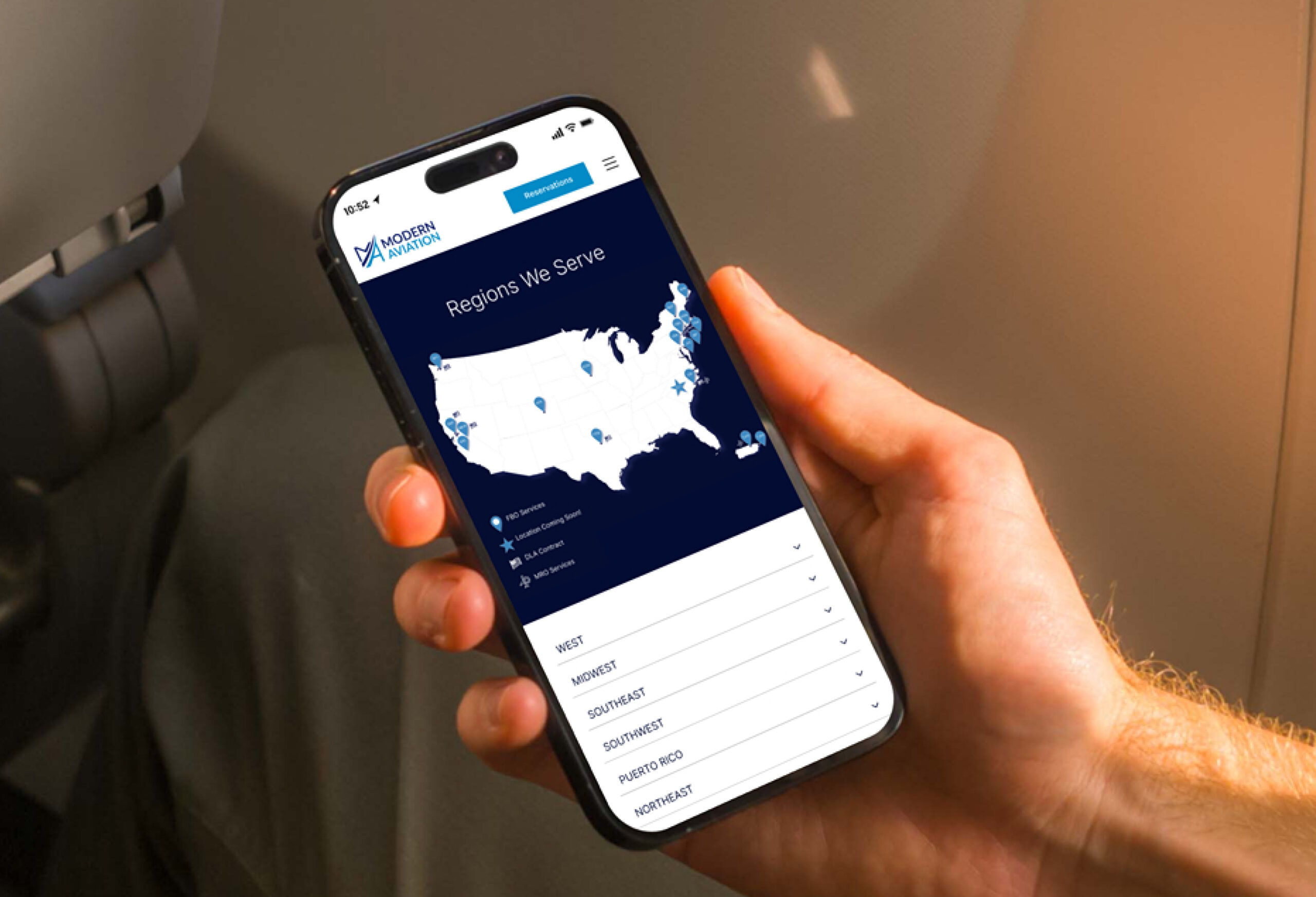 Mobile phone displaying app interface in hand