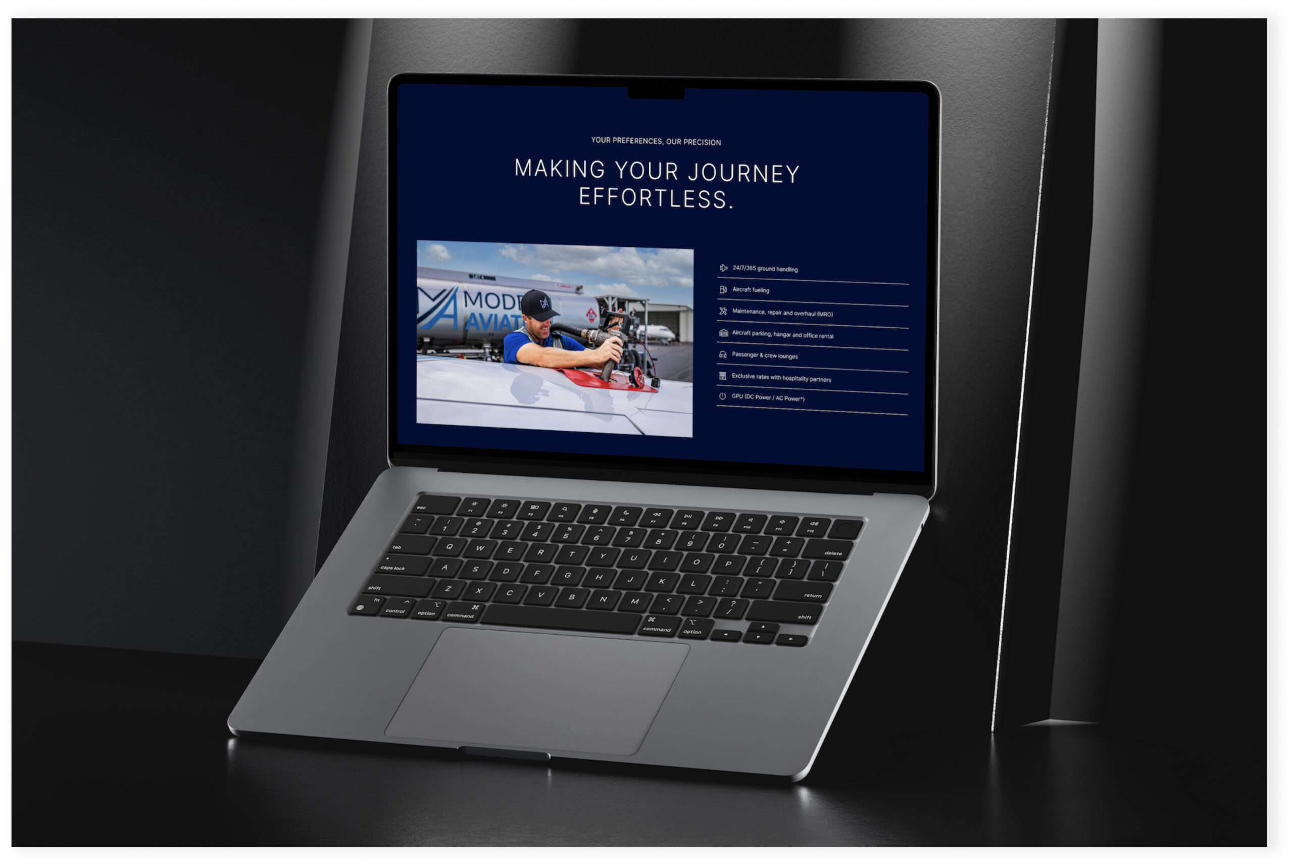 Laptop displaying website homepage with dark theme