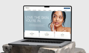 Laptop displaying website with user profile section