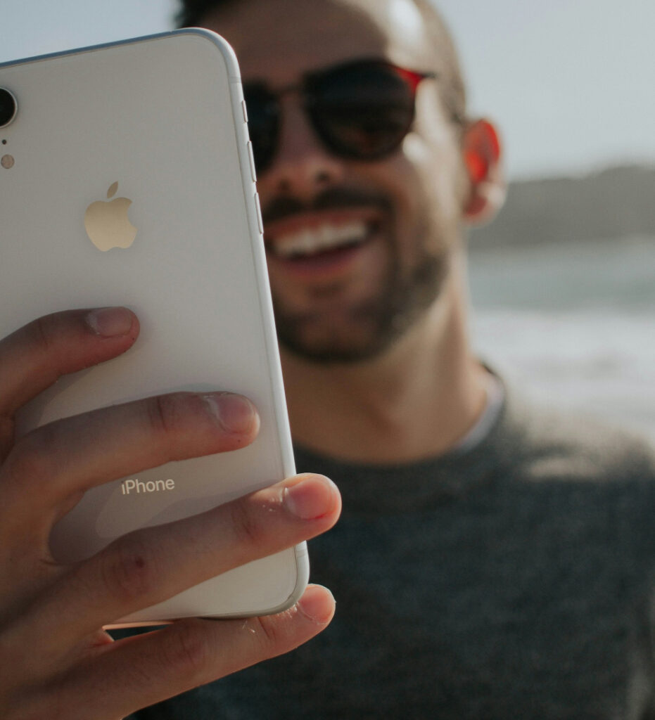 Person using smartphone in bright outdoor setting