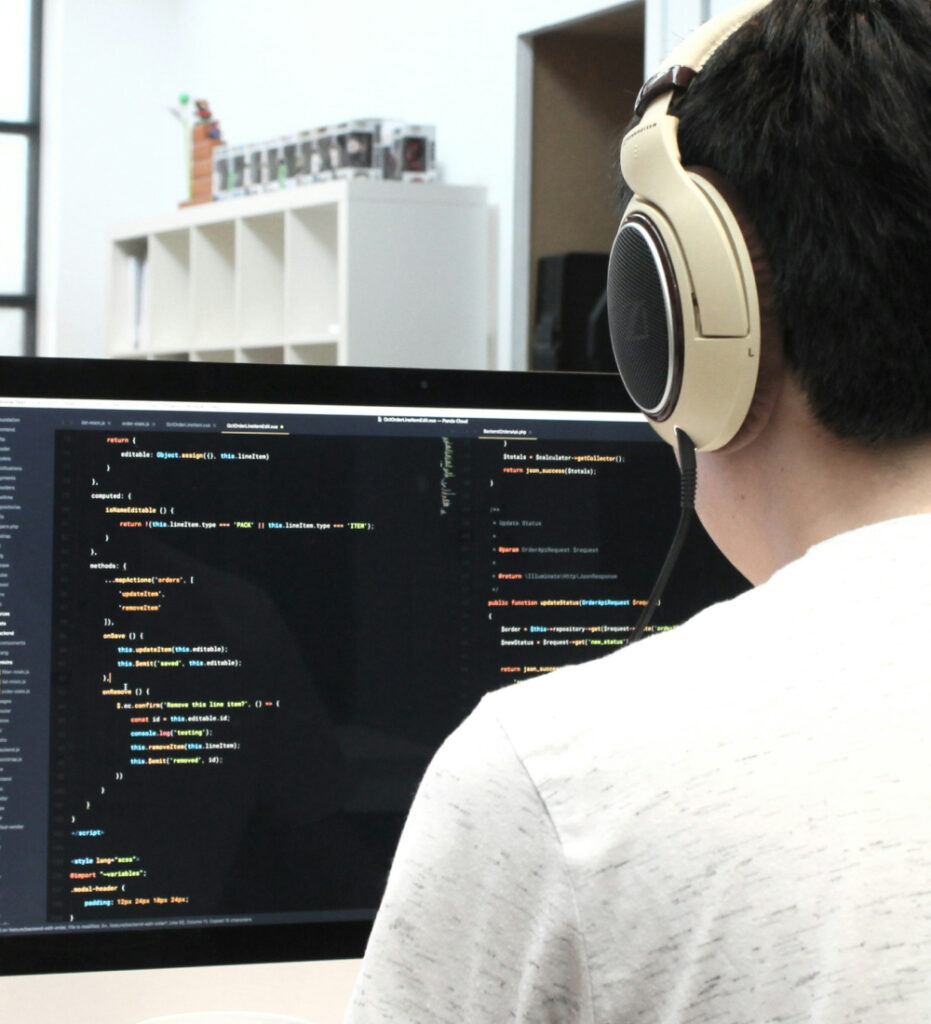 Developer coding on laptop in workspace
