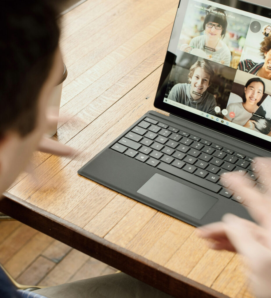 Person using laptop for video call and collaboration