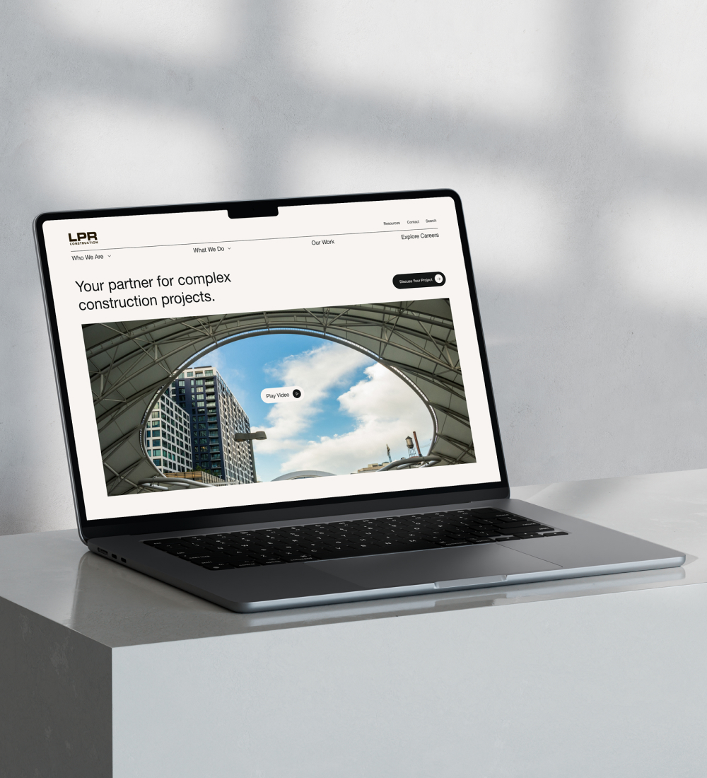 Laptop displaying website homepage on desk