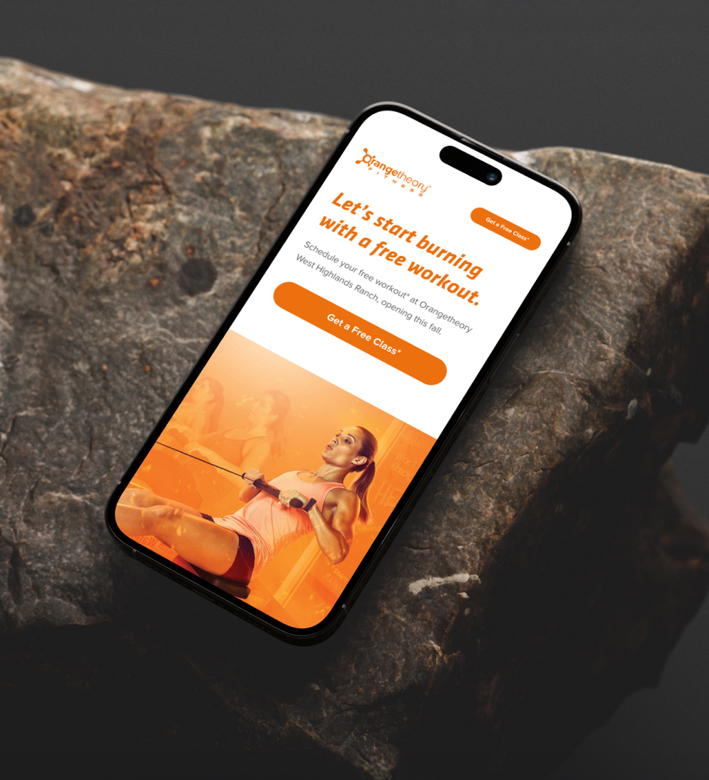 Smartphone displaying fitness app interface on stone surface