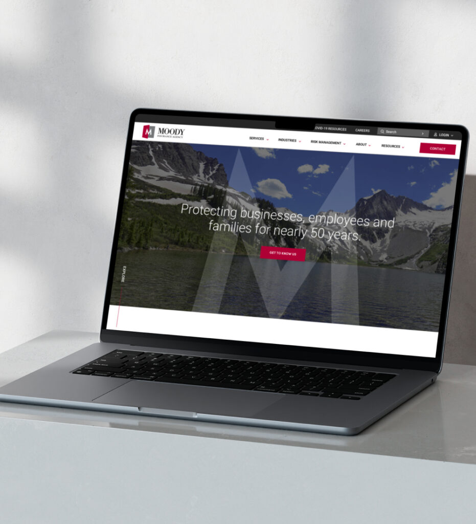 Laptop displaying website homepage on desk