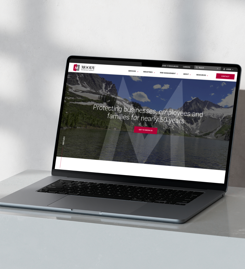 Laptop displaying website homepage on desk