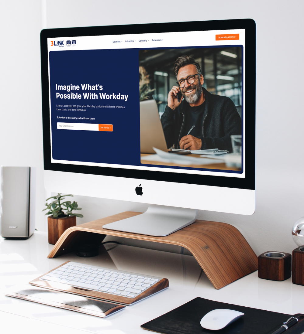 Desktop monitor displaying website homepage in workspace