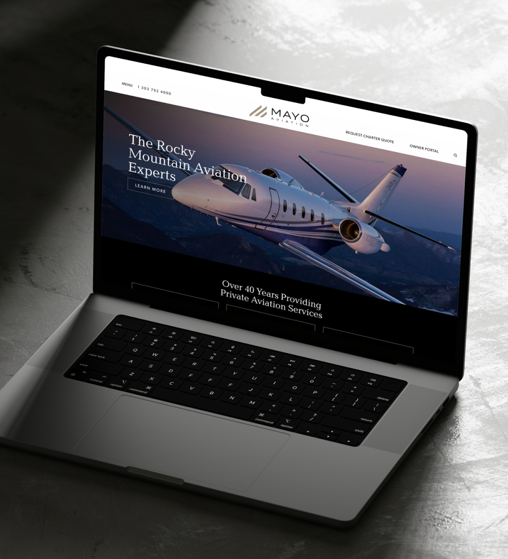 Laptop displaying aviation or travel website homepage