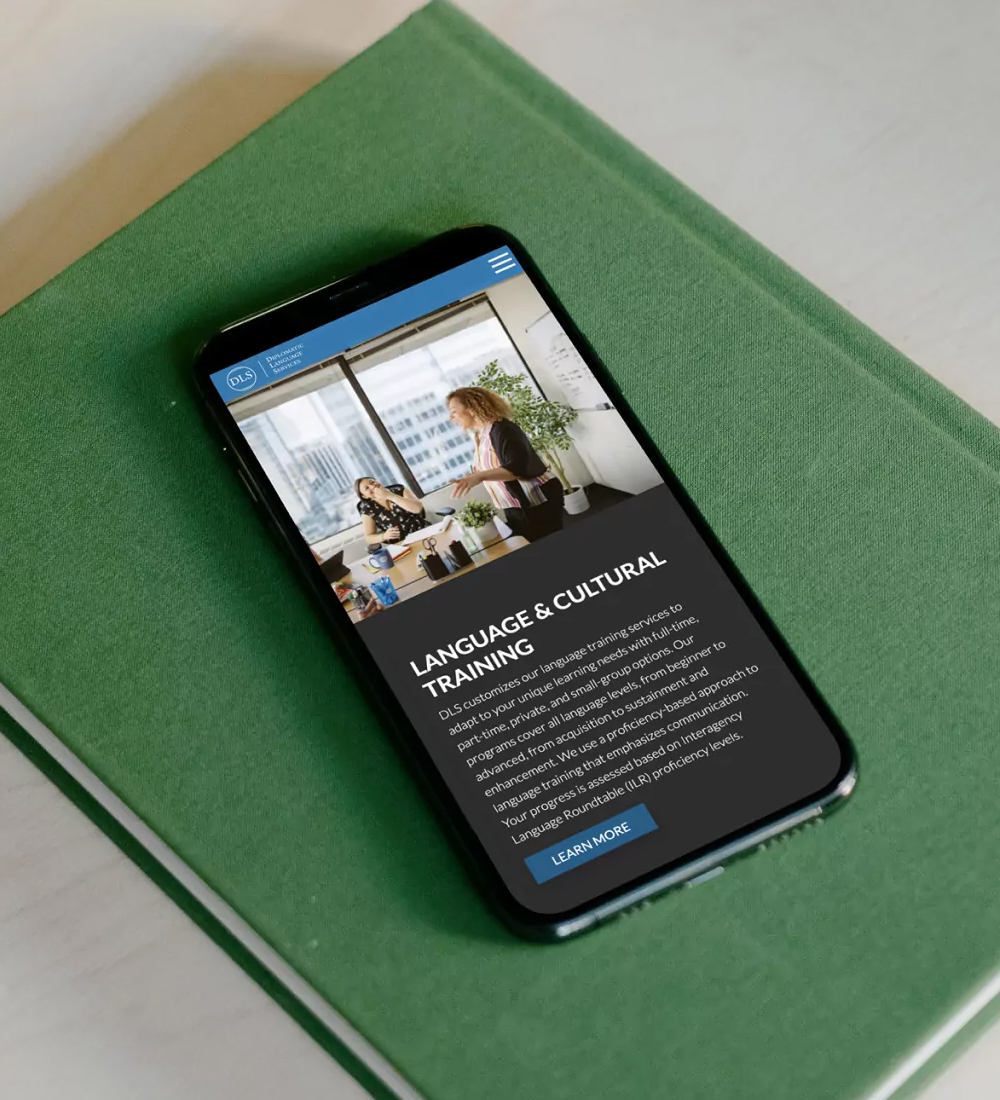 Smartphone displaying mobile website interface on green surface