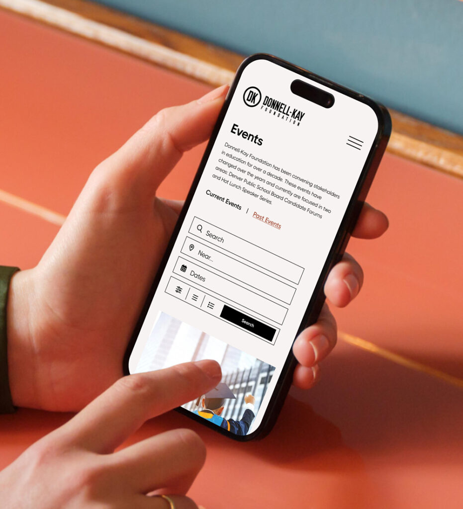 Smartphone displaying mobile website interface in hand