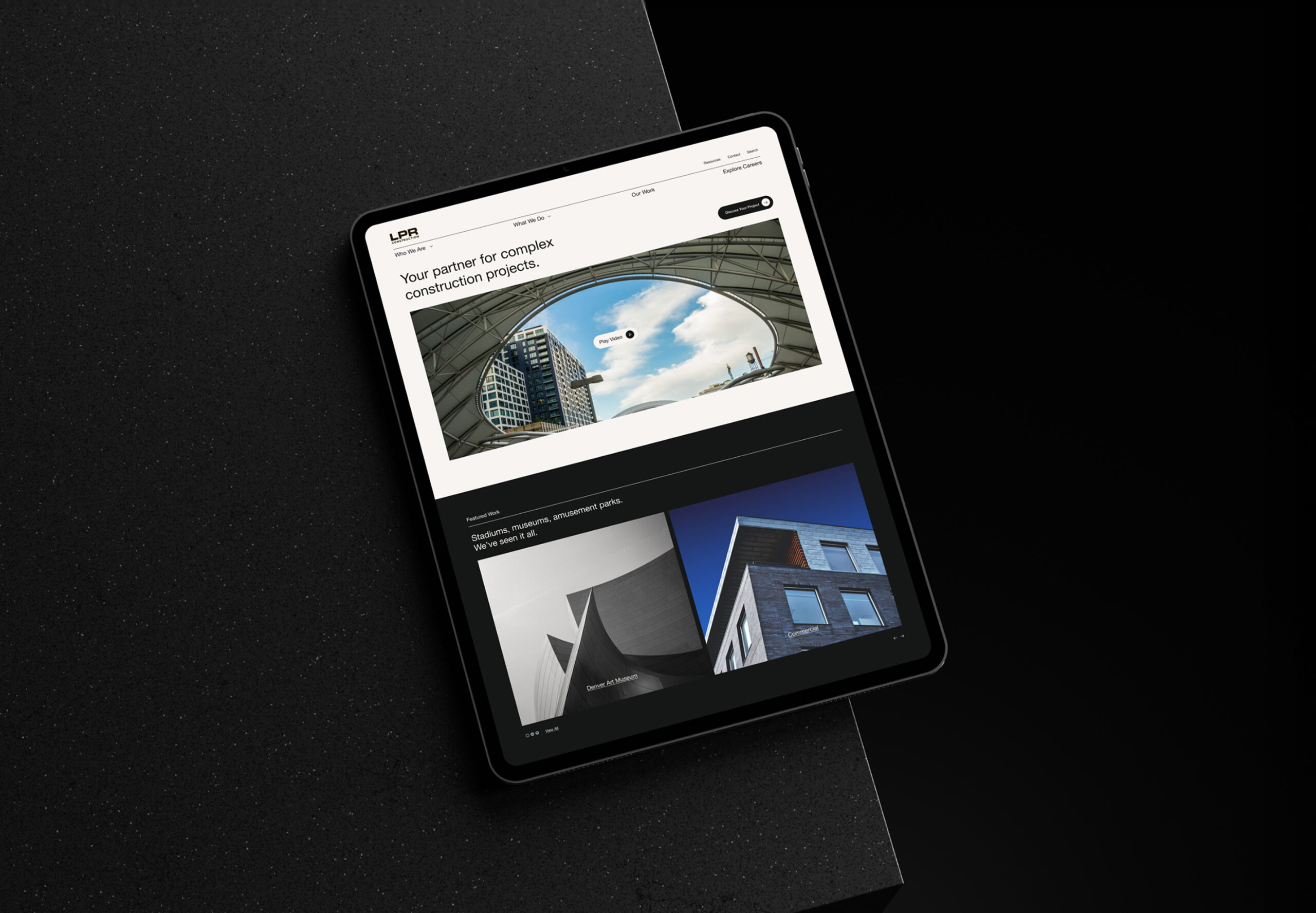 Tablet displaying website interface on dark background