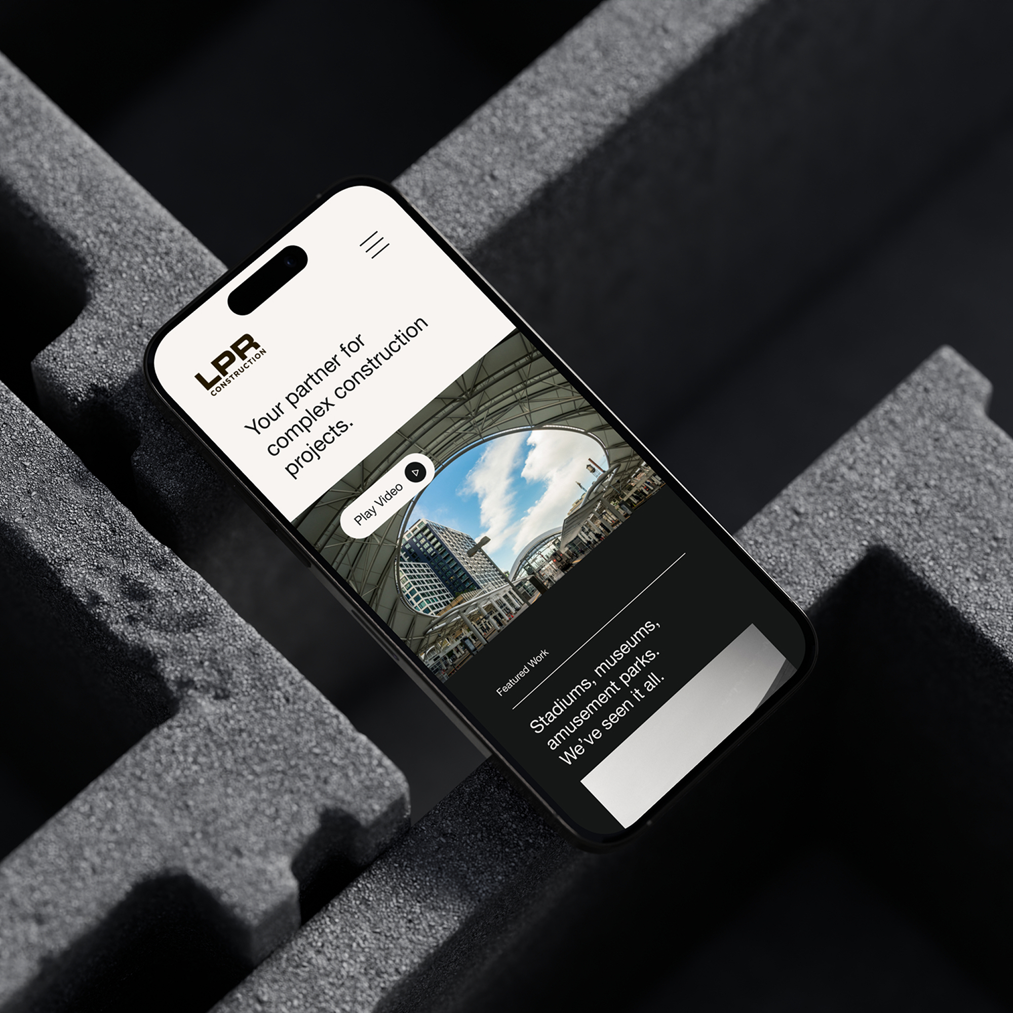 Smartphone displaying mobile website interface on stone surface