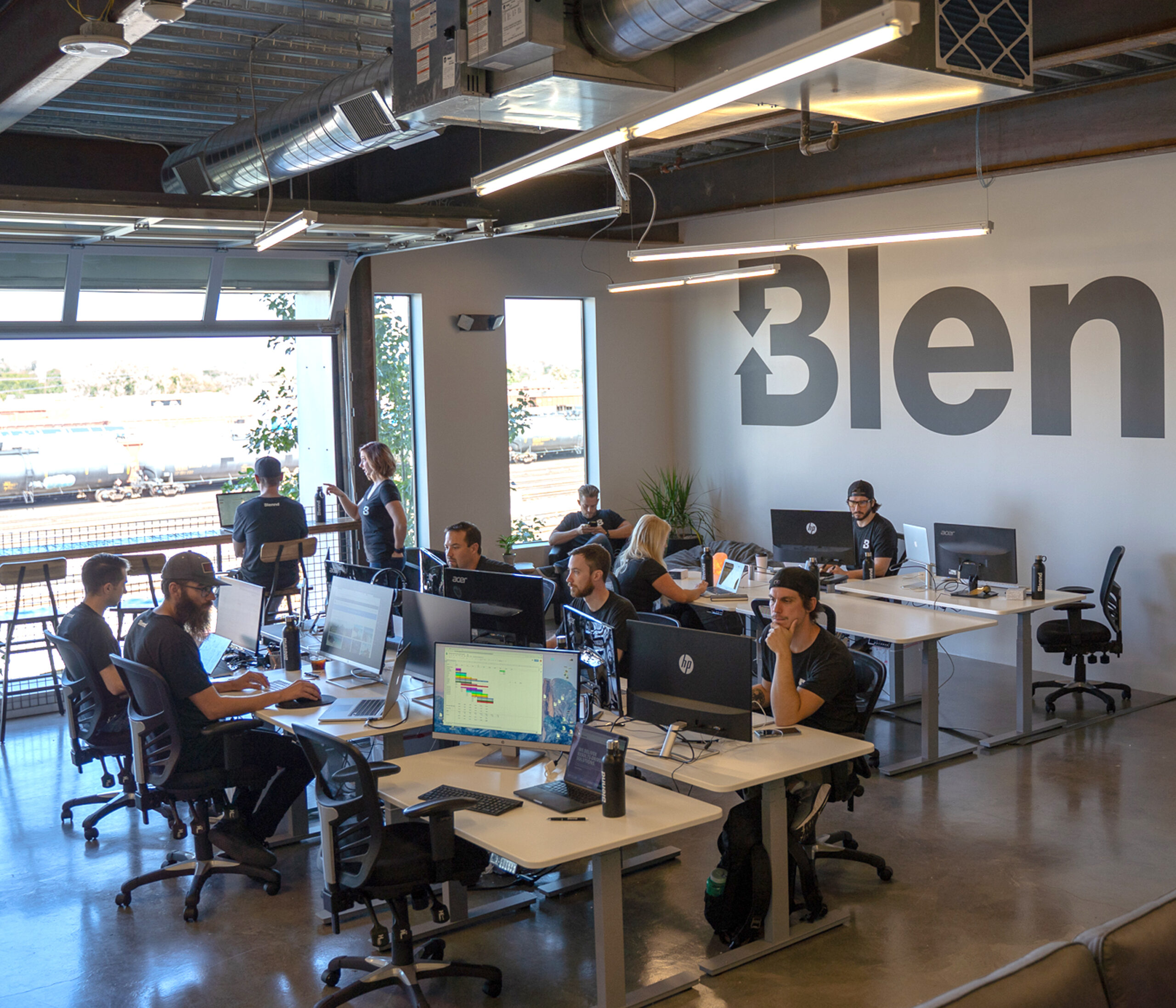 Open office workspace with Blennd team working