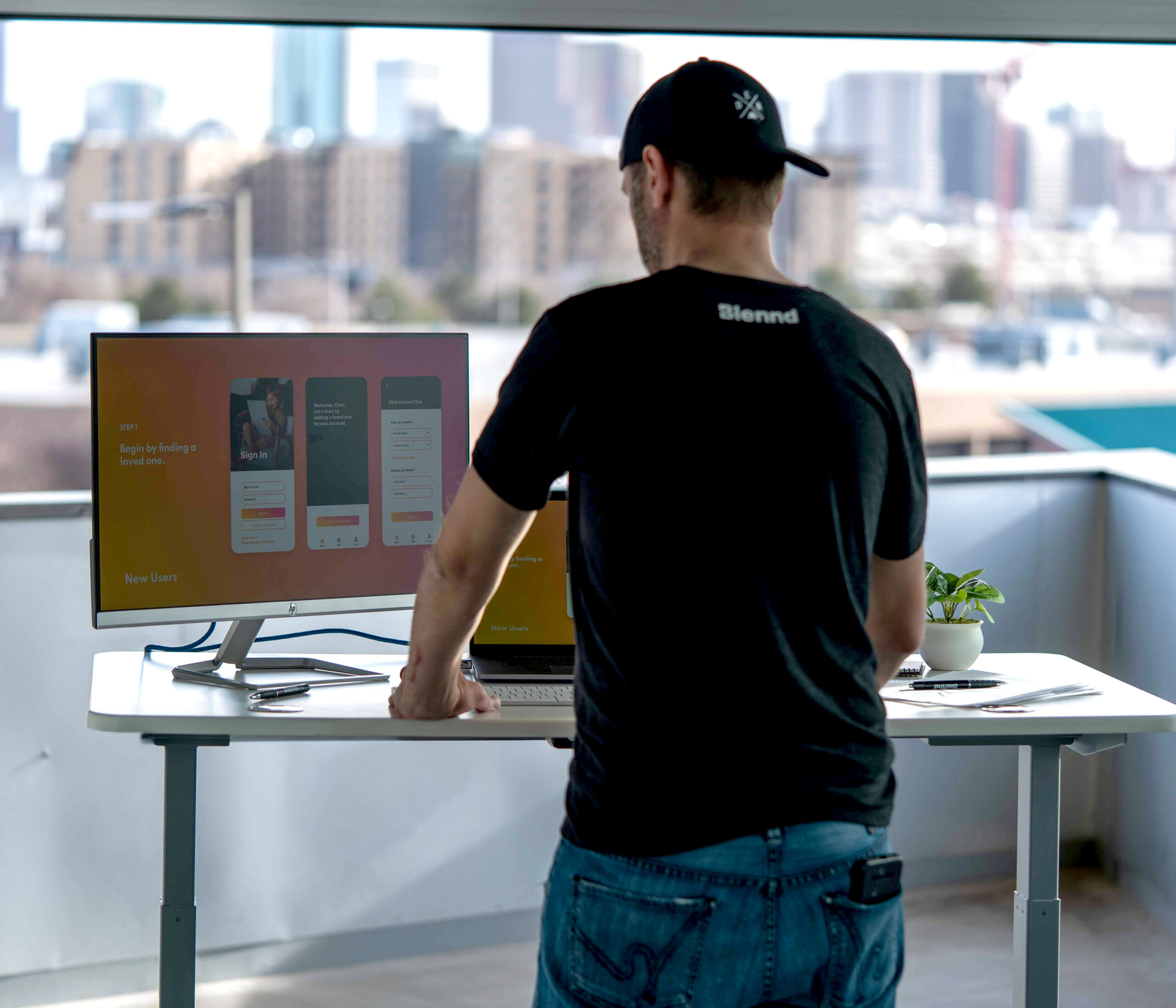 Team member reviewing website design on large monitor