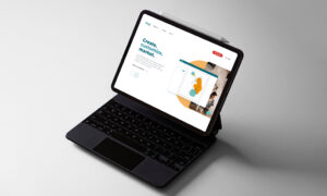 Laptop displaying website homepage design in workspace