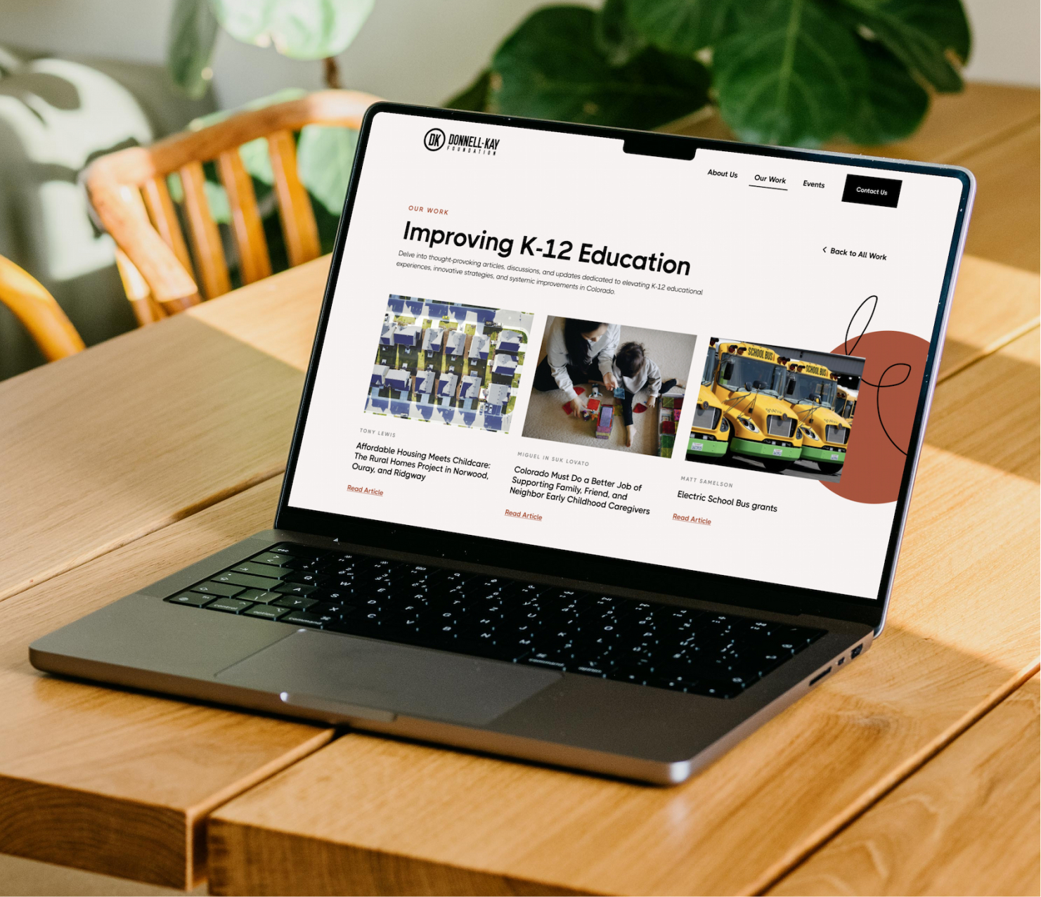 Laptop displaying website homepage on outdoor table