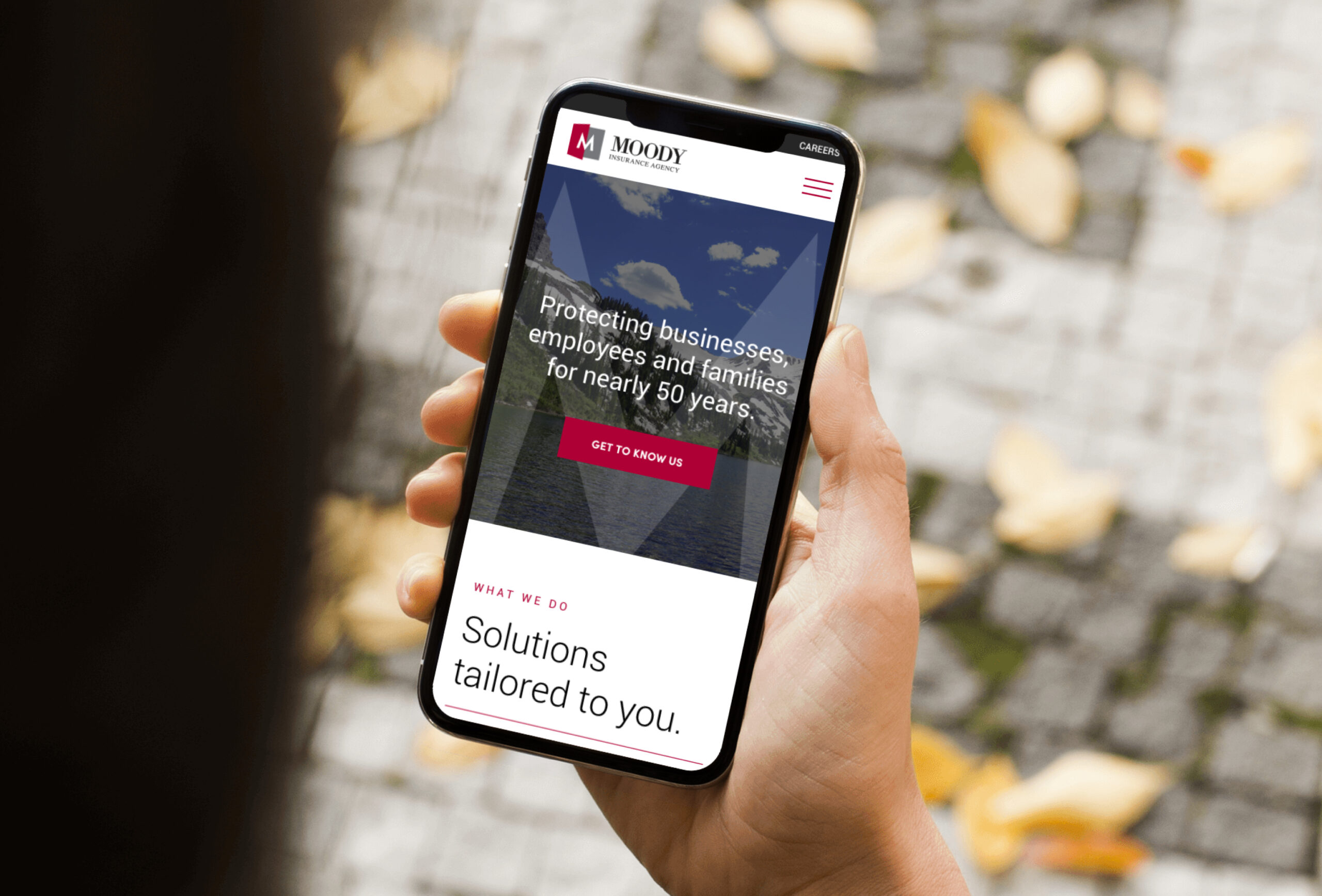 Smartphone displaying website interface outdoors