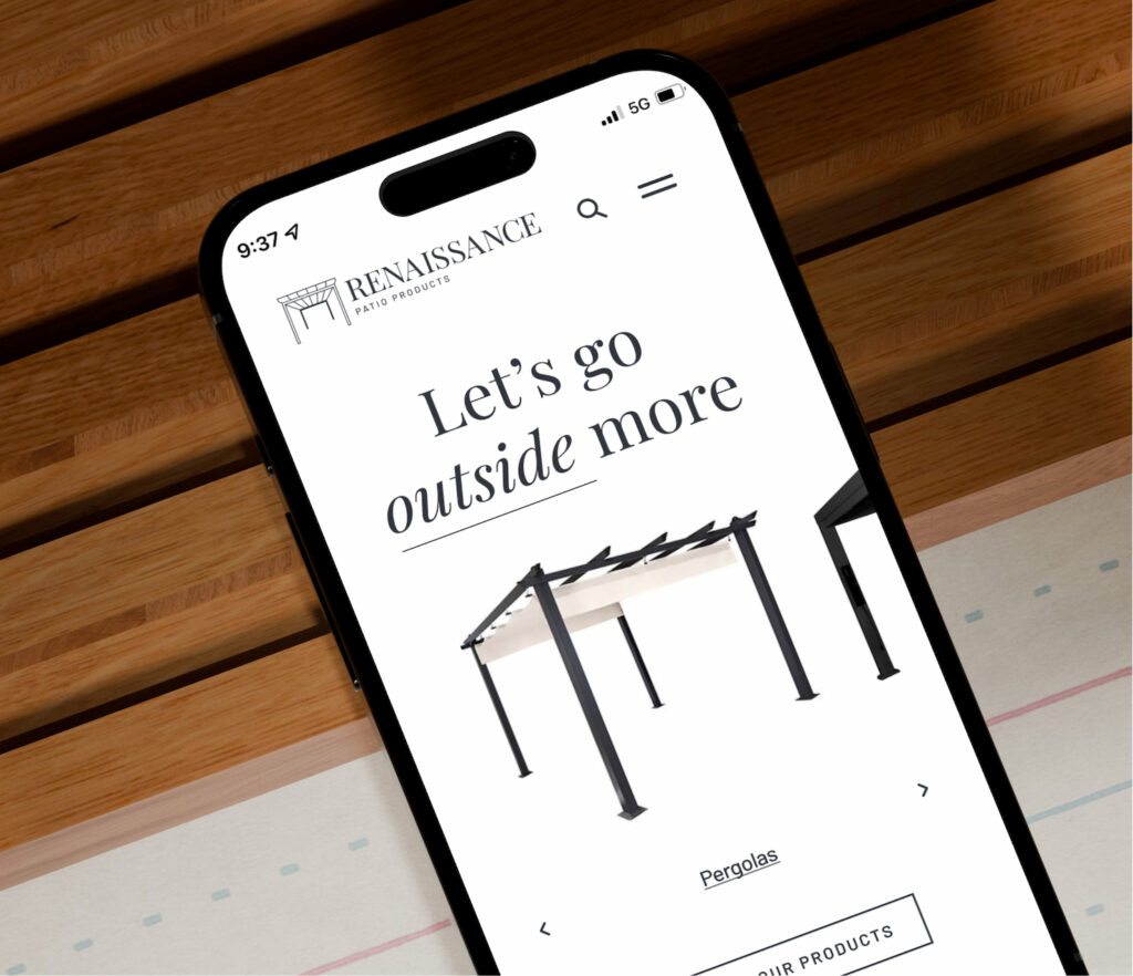 Mobile phone displaying minimal website interface on desk
