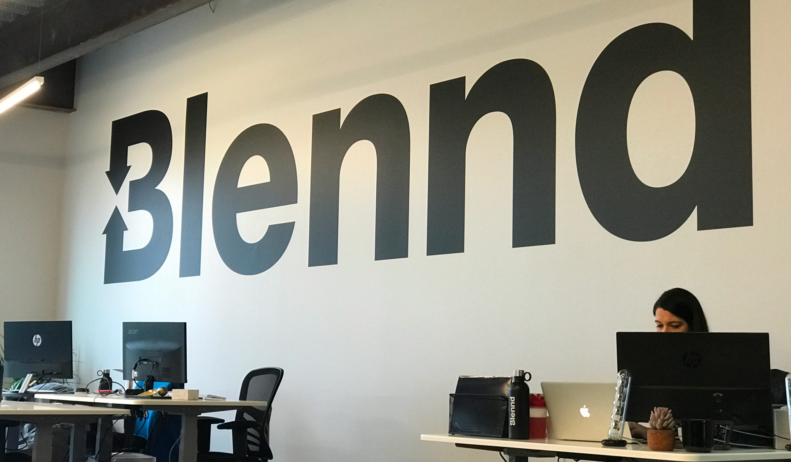 Blennd office reception area with logo wall