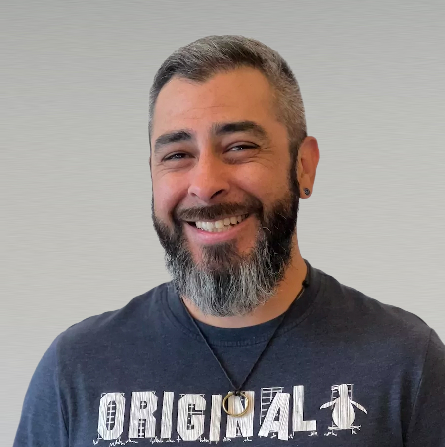 Professional headshot of male team member with beard