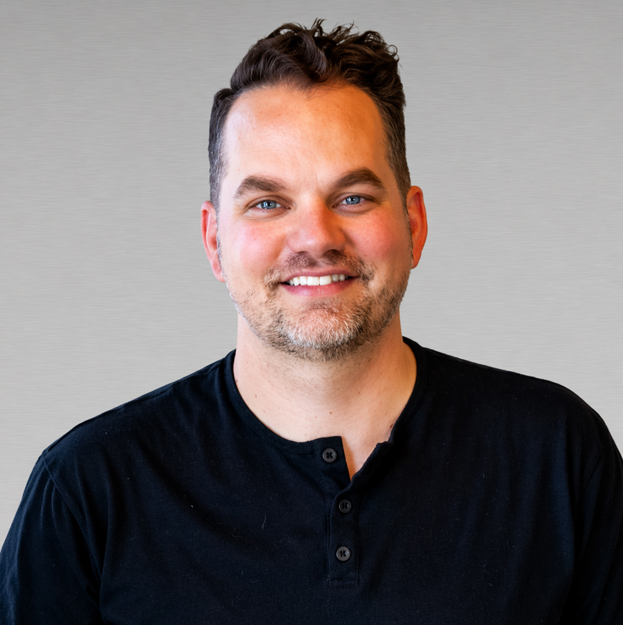 Professional headshot of male team member smiling