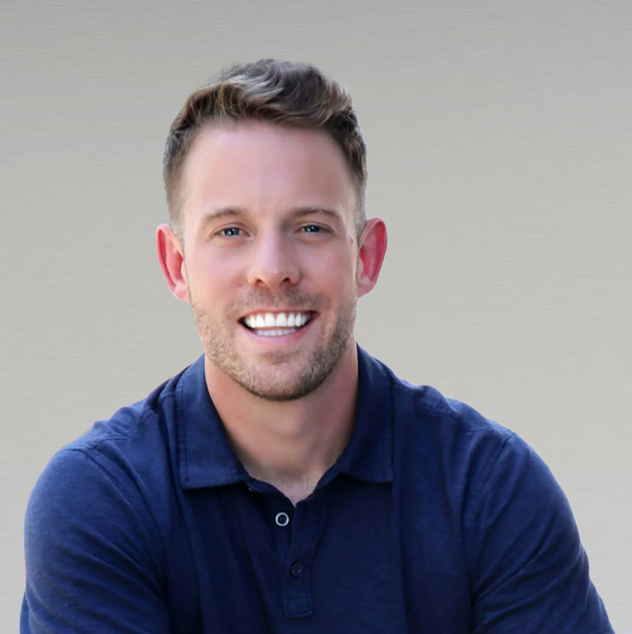 Professional headshot of male team member smiling