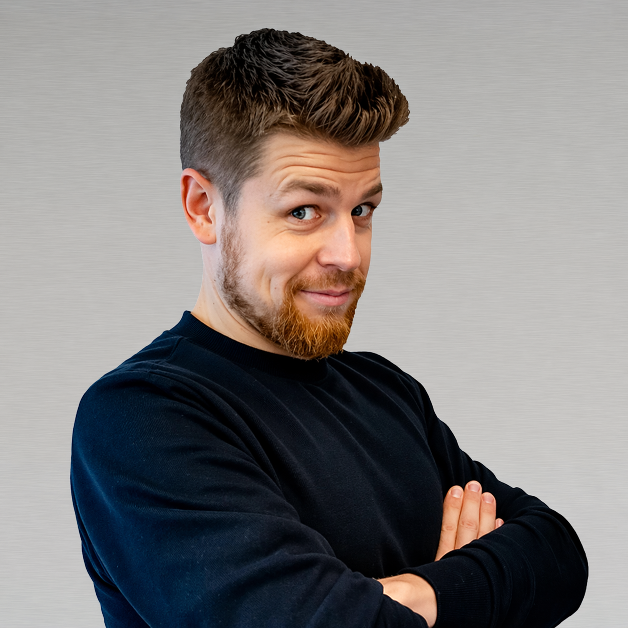 Professional headshot of male team member with arms crossed