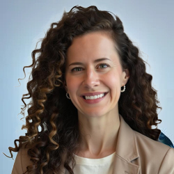 Professional headshot of female team member with curly hair